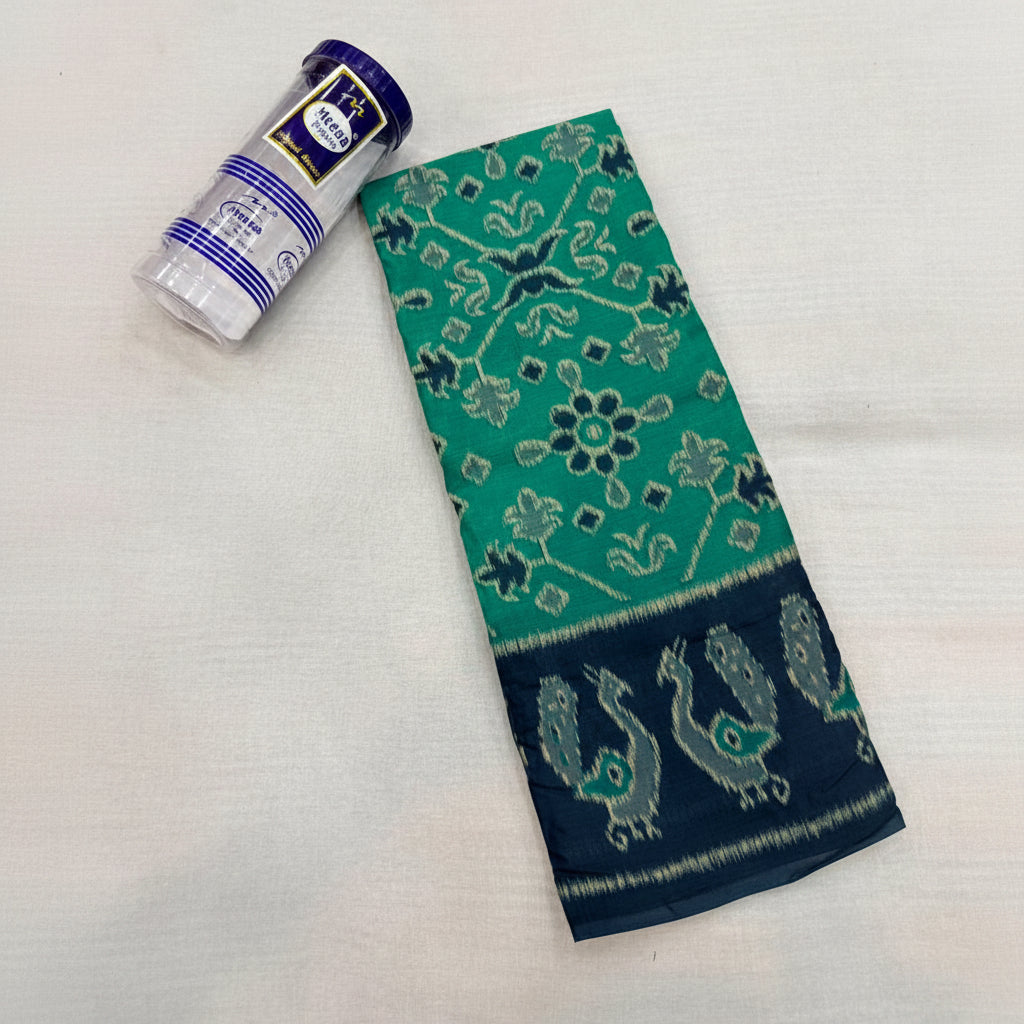 Teal and navy saree with peacock patterns on a light gray background